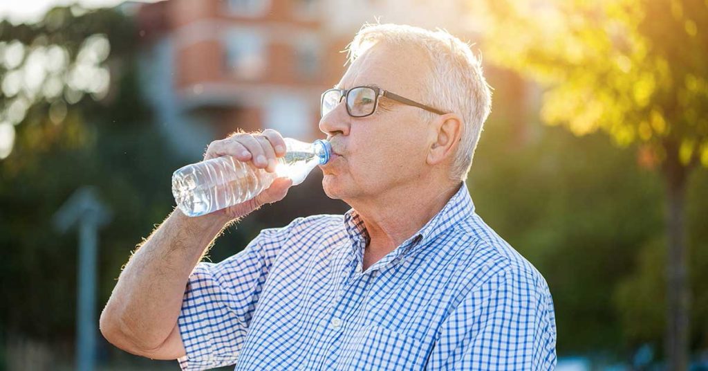 Senior drinking water to stay hydrated
